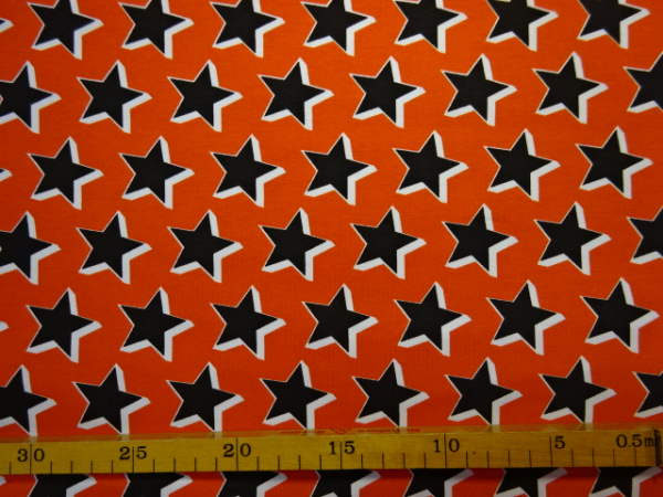 Jersey Digitaldruck schwarz weisse Sterne auf Orange 160 cm